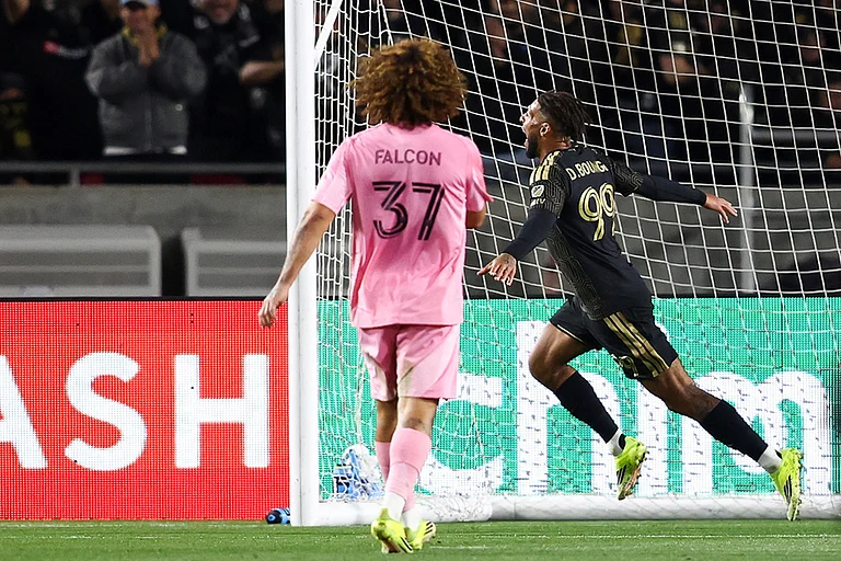 Los Angeles FC forward Denis Bouanga (99) celebrates after scoring a goal as Inter Miami defender Maximiliano Falcón (37) watches during the second half of an MLS soccer match in Los Angeles, Calif. - | Photo: AP/Jessie Alcheh