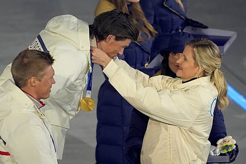 IOC President Kirsty Coventry, right, awards Johannes Hoesflot Klaebo, of Norway, the gold medal at medal ceremony for the cross country skiing men's 50km mass start classic during the closing ceremony of the 2026 Winter Olympics, in Verona, Italy, Sunday, Feb. 22, 2026.