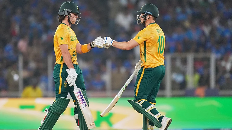 South Africa's Dewald Brevis, left, and batting partner David Miller touch gloves during the T20 World Cup cricket match between India and South Africa in Ahmedabad, India, Sunday, Feb. 22, 2026 - (AP Photo/Ajit Solanki)