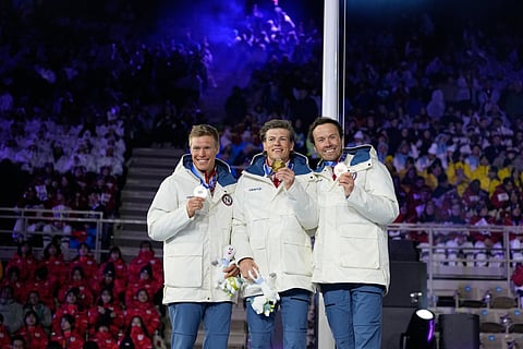 Bronze medalist Emil Iversen, of Norway, from right, gold medalist Johannes Hoesflot Klaebo, of Norway and silver medalist Martin Loewstroem Nyenget, of Norway, pose during a medal ceremony for the cross country skiing men's 50km mass start classic at the closing ceremony of the 2026 Winter Olympics, in Verona, Italy, Sunday, Feb. 22, 2026.