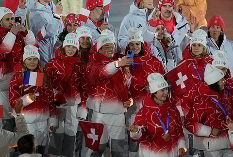 Swiss athletes take a selfie during the closing ceremony of the 2026 Winter Olympics, in Verona, Italy.