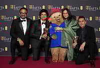 BAFTA Film Awards 2026 Winners — Photo Gallery | Photo: AP/Alastair Grant : Alan McAlex, from left, Farhan Akhtar, Paddington Bear, Lakshmipriya Devi, and Ritesh Sidhwani pose with the award for children's & family film for 'Boong' at the 79th British Academy Film Awards, BAFTA's, in London.