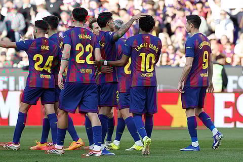 Barcelona players celebrate after a goal during a La Liga soccer match between Barcelona and Levante in Barcelona, Spain.