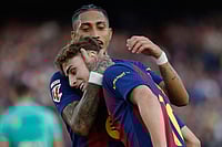 Barcelona Vs Levante, La Liga 2025-26: Barca Cruise To 3–0 Win To Reclaim Top Spot | Photo: AP/Joan Monfort : Barcelona's Raphinha hugs Fermin Lopez after a goal during a La Liga soccer match between Barcelona and Levante in Barcelona, Spain.