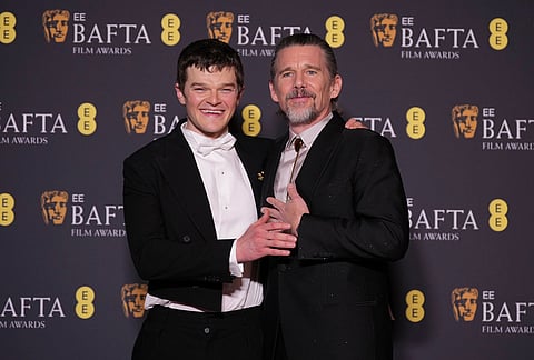 Ethan Hawke, right, and Robert Aramayo, winner of the EE rising star award and the award for leading actor for 'I Swear' pose for photographers at the 79th British Academy Film Awards, BAFTA's, in London.