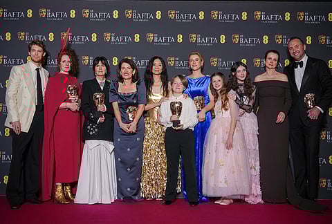 Joe Alwyn, from left, Maggie O'Farrell, Liza Marshall, Pippa Harris, Chloe Zhao, Jacobi Jupe, Jessie Buckley, Olivia Lynes, Bodhi Rae Breathnach, Emily Watson, Nicolas Gonda pose with the award for outstanding British film for 'Hamnet' at the 79th British Academy Film Awards, BAFTA's, in London.