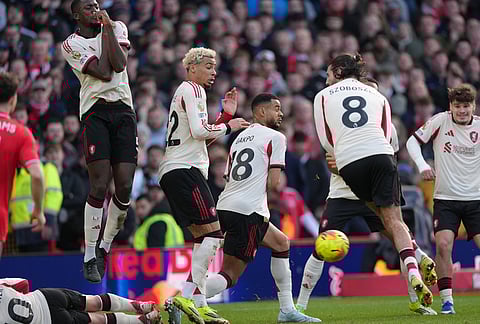 Liverpool players jump during a free kick during the English Premier League soccer match between Nottingham Forest and Liverpool in Nottingham.