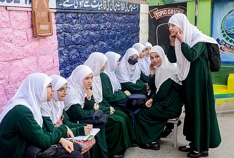 Students interact with each other at a school on the first day of classes after the winter vacation, in Srinagar, Jammu and Kashmir.