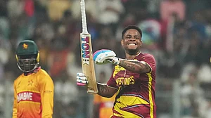 AP Photo/Rafiq Maqbool : West Indies' Shimron Hetmyer celebrates his fifty runs during the T20 World Cup cricket match between Zimbabwe and West Indies in Mumbai, India, Monday, Feb. 23, 2026.