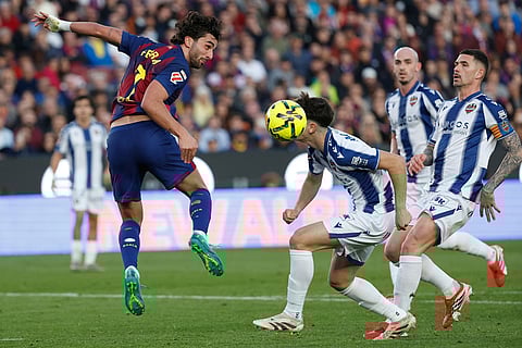 Barcelona's Ferran Torres heads the ball during a La Liga soccer match between Barcelona and Levante in Barcelona, Spain.