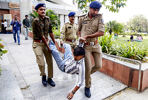 Police detain National Students' Union of India (NSUI) members as they protest over Gujarat University’s RSS Exhibition, in Ahmedabad.