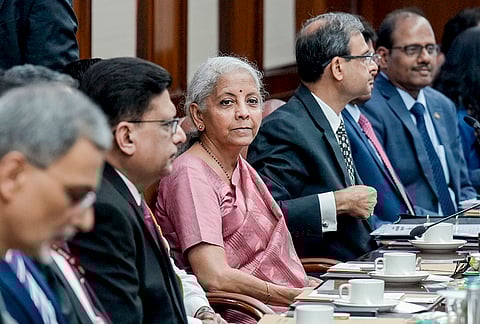 Finance Minister Nirmala Sitharaman, centre, RBI Governor Sanjay Malhotra, second right, and others during a press conference after a Central Board meeting of the Reserve Bank of India, at the RBI headquarters, in New Delhi.