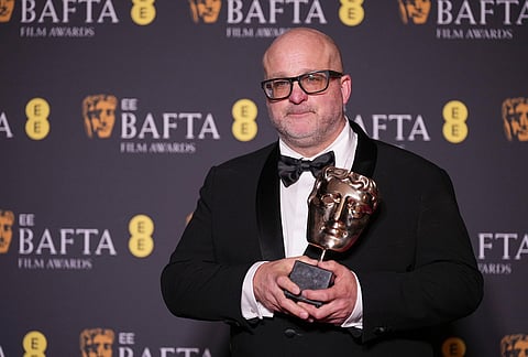 Michael Bauman poses with the award for cinematography for 'One Battle After Another' at the 79th British Academy Film Awards, BAFTA's, in London.