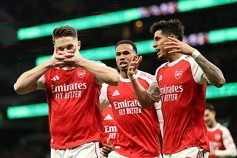 Arsenal's Viktor Gyoekeres, left, celebrates scoring his side's second goal during the English Premier League soccer match between Tottenham Hotspur and Arsenal in London.