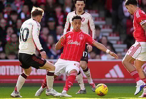 Liverpool's Alexis Mac Allister, left, and Nottingham Forest's Omari Hutchinson challenge for the ball during the English Premier League soccer match between Nottingham Forest and Liverpool in Nottingham.