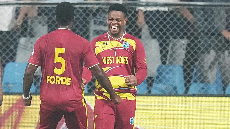 West Indies' Matthew Forde celebrates with Shimron Hetmyer, right, the wicket of Zimbabwe's Tadiwanashe Marumani during the T20 World Cup cricket match between Zimbabwe and West Indies in Mumbai, India, Monday, Feb. 23, 2026. - | Photo: AP/Rafiq Maqbool