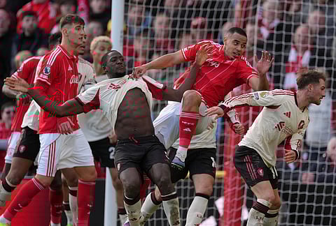 Liverpool and Nottingham Forest players challenge for the ball during the English Premier League soccer match between Nottingham Forest and Liverpool in Nottingham.