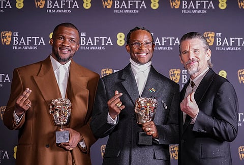 Wale Davies, from left, Akinola Davies Jr., and Ethan Hawke pose with the award for outstanding debut by a British writer, director or producer for 'My Father's Shadow' at the 79th British Academy Film Awards, BAFTA's, in London.
