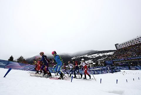 Skiers, including Italy's Alba de Silvestro, foreground, and France's Emily Harrop, center left, start a ski mountaineering mixed relay, at the 2026 Winter Olympics, in Bormio, Italy, Saturday, Feb. 21, 2026. 