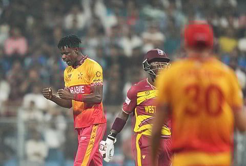 Zimbabwe's Blessing Muzarabani celebrates the wicket of West Indies' Rovman Powell during the T20 World Cup cricket match between Zimbabwe and West Indies in Mumbai.