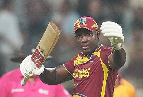 West Indies' Rovman Powell celebrates his fifty runs during the T20 World Cup cricket match between Zimbabwe and West Indies in Mumbai.