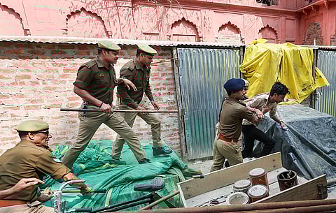 Police personnel detain Akhil Bharatiya Vidyarthi Parishad (ABVP) activists after they reach Lal Baradari mosque to chant the Hanuman Chalisa, at the University of Lucknow.