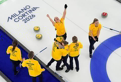 Sweden team celebrates after winning the women's curling gold medal match between Switzerland and Sweden, at the 2026 Winter Olympics, in Cortina d'Ampezzo, Italy, Sunday, Feb. 22, 2026. 