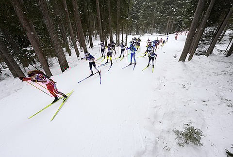 Maren Kirkeeide, of Norway, left, competes in the women's 12.5-kilometer mass start biathlon race at the 2026 Winter Olympics in Anterselva, Italy, Saturday, Feb. 21, 2026. 