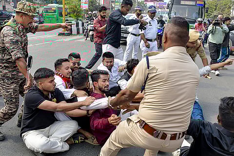 Security personnel detain members of the National Students' Union of India (NSUI), the student wing of the Indian National Congress, during a protest titled 'Chhatra Hunkaar' in front of Raj Bhavan, in Guwahati.