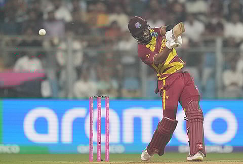 West Indies' captain Shai Hope hits a boundary during the T20 World Cup cricket match between Zimbabwe and West Indies in Mumbai.