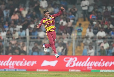 West Indies' Gudakesh Motie celebrates the wicket of Zimbabwe's Tashinga Musekiwa during the T20 World Cup cricket match between Zimbabwe and West Indies in Mumbai.