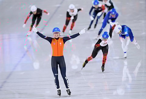 Marijke Groenewoud of the Netherlands celebrates winning the gold medal ahead of Ivanie Blondin of Canada, center right and silver medal, and Mia Manganello of the U.S., far right and bronze medal, in the women's mass start final speedskating race at the 2026 Winter Olympics, in Milan, Italy.