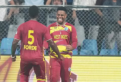West Indies' Matthew Forde celebrates with Shimron Hetmyer, right, the wicket of Zimbabwe's Tadiwanashe Marumani during the T20 World Cup cricket match between Zimbabwe and West Indies in Mumbai.