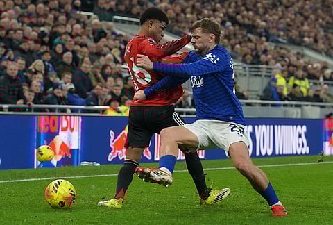 Manchester United's Amad Diallo, left, and Everton's Kiernan Dewsbury-Hall fight for the ball during the Premier League soccer match between Manchester United and Everton in Liverpool, England.