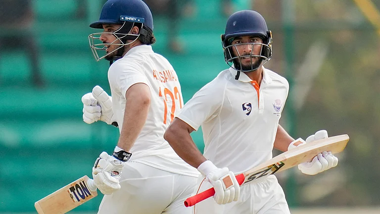 Jammu and Kashmir's Shubham Pundir and Abdul Samad run between the wickets during the first day of the Ranji Trophy 2025-26 final cricket match between Karnataka and Jammu & Kashmir, at KSCA Cricket Stadium, in Hubballi, Karnataka, Tuesday, Feb. 24, 2026. - (PTI Photo/Shailendra Bhojak)