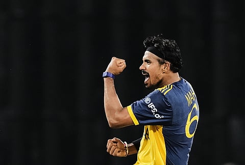 Sri Lanka's Maheesh Theekshana celebrates the wicket of New Zealand's Mark Chapman during the T20 World Cup cricket match between Sri Lanka and New Zealand in Colombo, Sri Lanka.