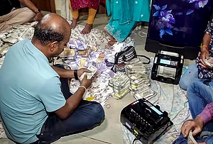 | Photo: PTI : Odisha Vigilance officials count seized cash during a raid at the residence of arrested Deputy Director of Mines Debabrata Mohanty in connection with a bribery case, in Bhubaneswar. Over Rs 4 crore in cash was recovered during the raids, officials said.