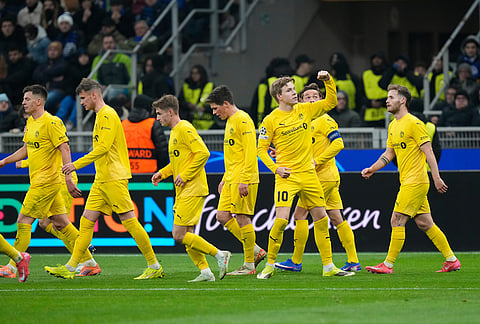 Glimt's Jens Petter Hauge celebrates with team mates after scoring his side's first goal during a Champions League playoff soccer match between Inter Milan and Bodo Glimt, at the San Siro stadium in Milan, Italy.