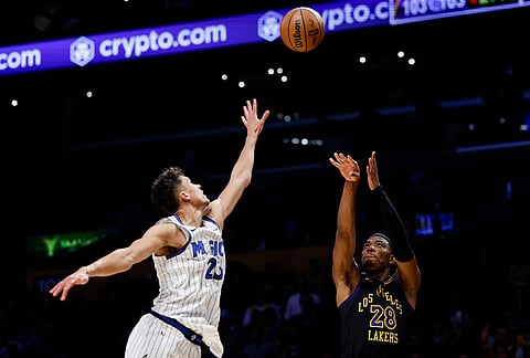 Los Angeles Lakers forward Rui Hachimura (28) shoots a 3-pointer while being guarded by Orlando Magic forward Tristan da Silva (23) during the second half of an NBA basketball game in Los Angeles. 