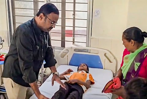 An injured student undergoes treatment after a school vehicle he was travelling in allegedly overturned, near Mallapur, in Jagtial, Telangana.