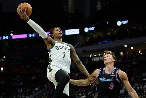 Milwaukee Bucks' Kevin Porter Jr. (7) drives to the basket against Miami Heat's Pelle Larsson during the first half of an NBA basketball game in Milwaukee. 