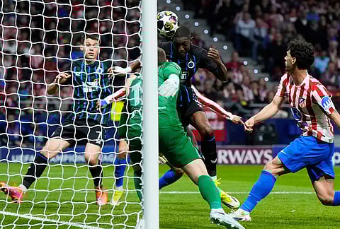 Brugge's Joel Ordonez, center, scores his side's first goal during the Champions League play-off second leg soccer match between Atletico Madrid and Club Brugge, in Madrid, Spain.