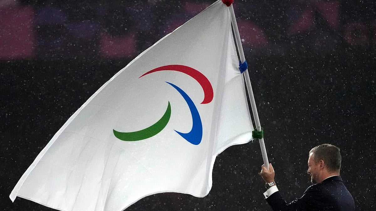 FILE - President of the International Paralympic Committee Andrew Parsons passes the Paralympic flag to Mayor of Los Angeles Karen Bass, not pictured, after receiving it from Mayor of Paris Anne Hidalgo, not pictured, during the closing ceremony of the 2024 Paralympics, Sept. 8, 2024, in Paris. - (AP Photo/Michel Euler, File)