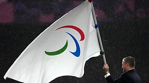 (AP Photo/Michel Euler, File) : FILE - President of the International Paralympic Committee Andrew Parsons passes the Paralympic flag to Mayor of Los Angeles Karen Bass, not pictured, after receiving it from Mayor of Paris Anne Hidalgo, not pictured, during the closing ceremony of the 2024 Paralympics, Sept. 8, 2024, in Paris.