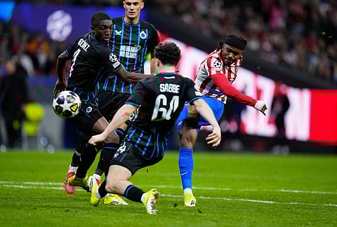 Atletico Madrid's Ademola Lookman, right, makes an attempt to score during the Champions League play-off second leg soccer match between Atletico Madrid and Club Brugge, in Madrid, Spain.