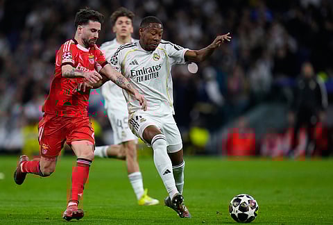 Real Madrid's Aurelien Tchouameni, right, and Benfica's Rafa Silva challenge for the ball during the second leg of the Champions League playoff soccer match between Real Madrid and Benfica in Madrid, Spain.