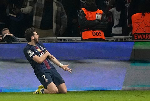 PSG's Khvicha Kvaratskhelia celebrates after scoring during a Champions League second leg playoff soccer match between Paris Saint-Germain and Monaco in Paris.