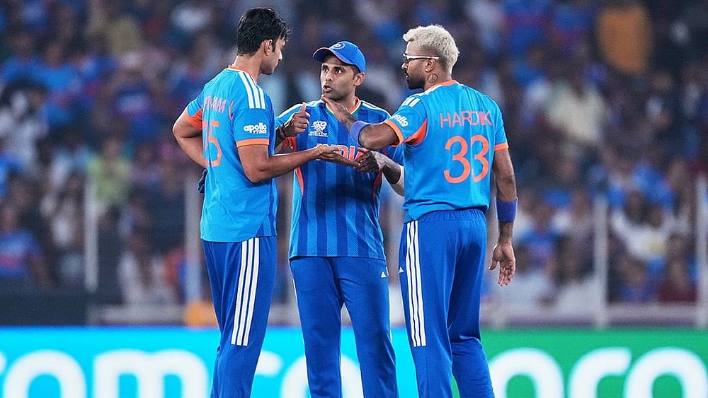 India's Shivam Dube, left, captain Suryakumar Yadav and Hardik Pandya have a chat during the T20 World Cup cricket match between India and Netherlands in Ahmedabad. - | Photo: AP/Ajit Solanki
