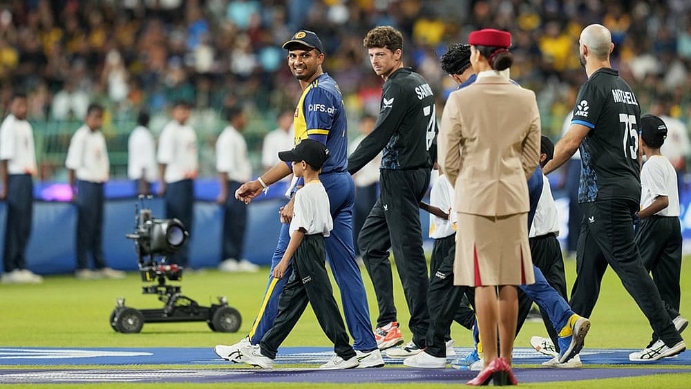 Sri Lanka's captain Dasun Shanaka, left, and New Zealand's captain Mitchel Santner arrive for their national anthem before the start of their T20 World Cup cricket match between Sri Lanka and New Zealand in Colombo, Sri Lanka. - | Photo: AP/Eranga Jayawardena