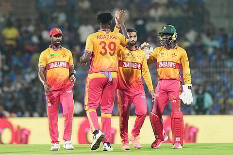 Zimbabwe's captain Sikandar Raza, second left, celebrates with teammates the wicket of India's Ishan Kishan during the T20 World Cup cricket match between India and Zimbabwe in Chennai, India.